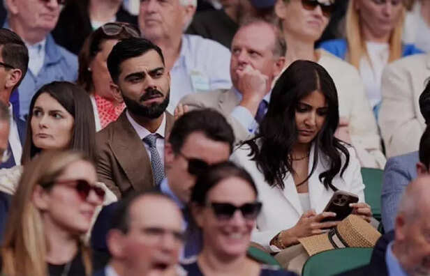 Virat Kohli (L) attends W
